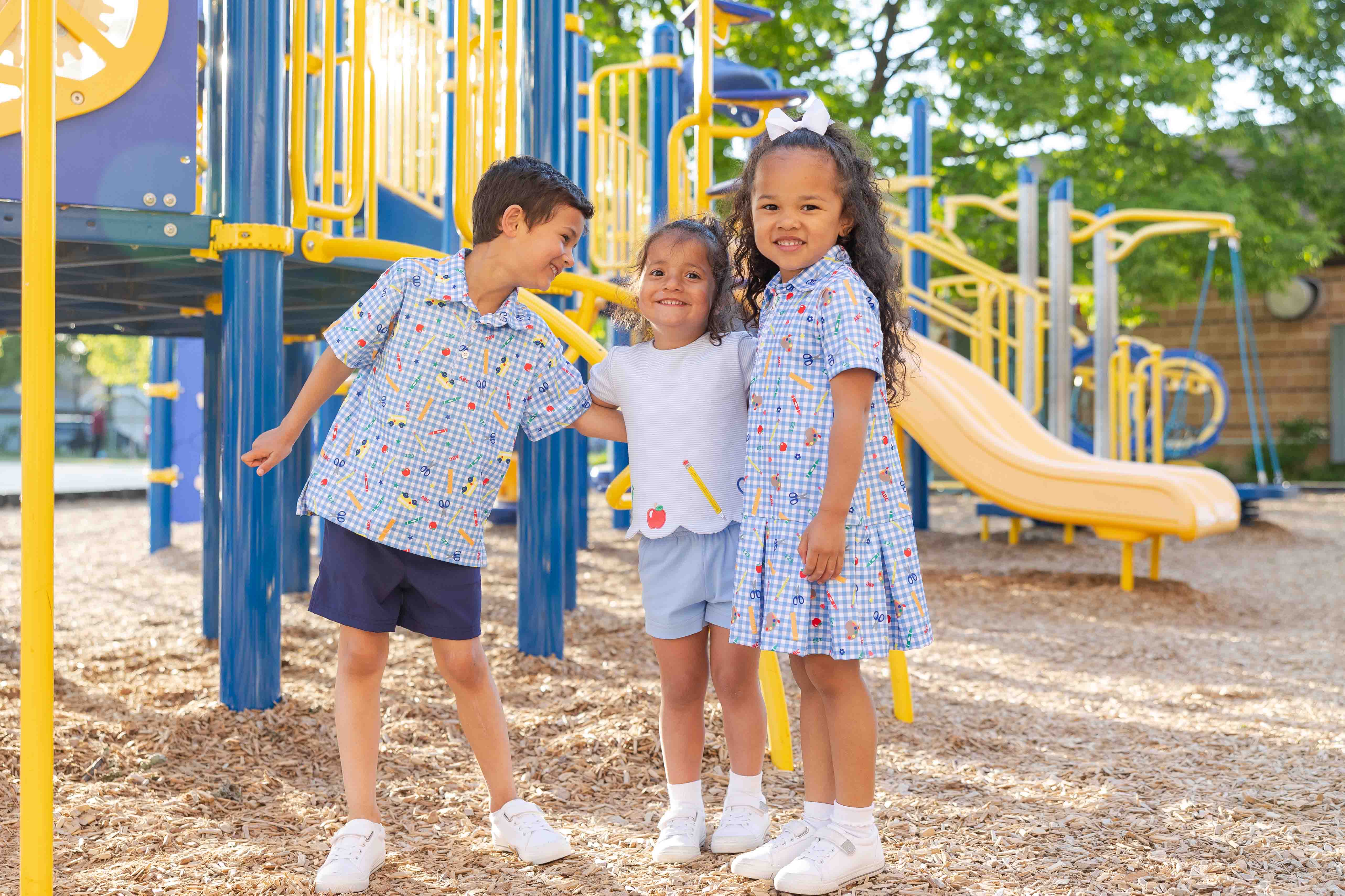 two children in spring clothing with baby chicks