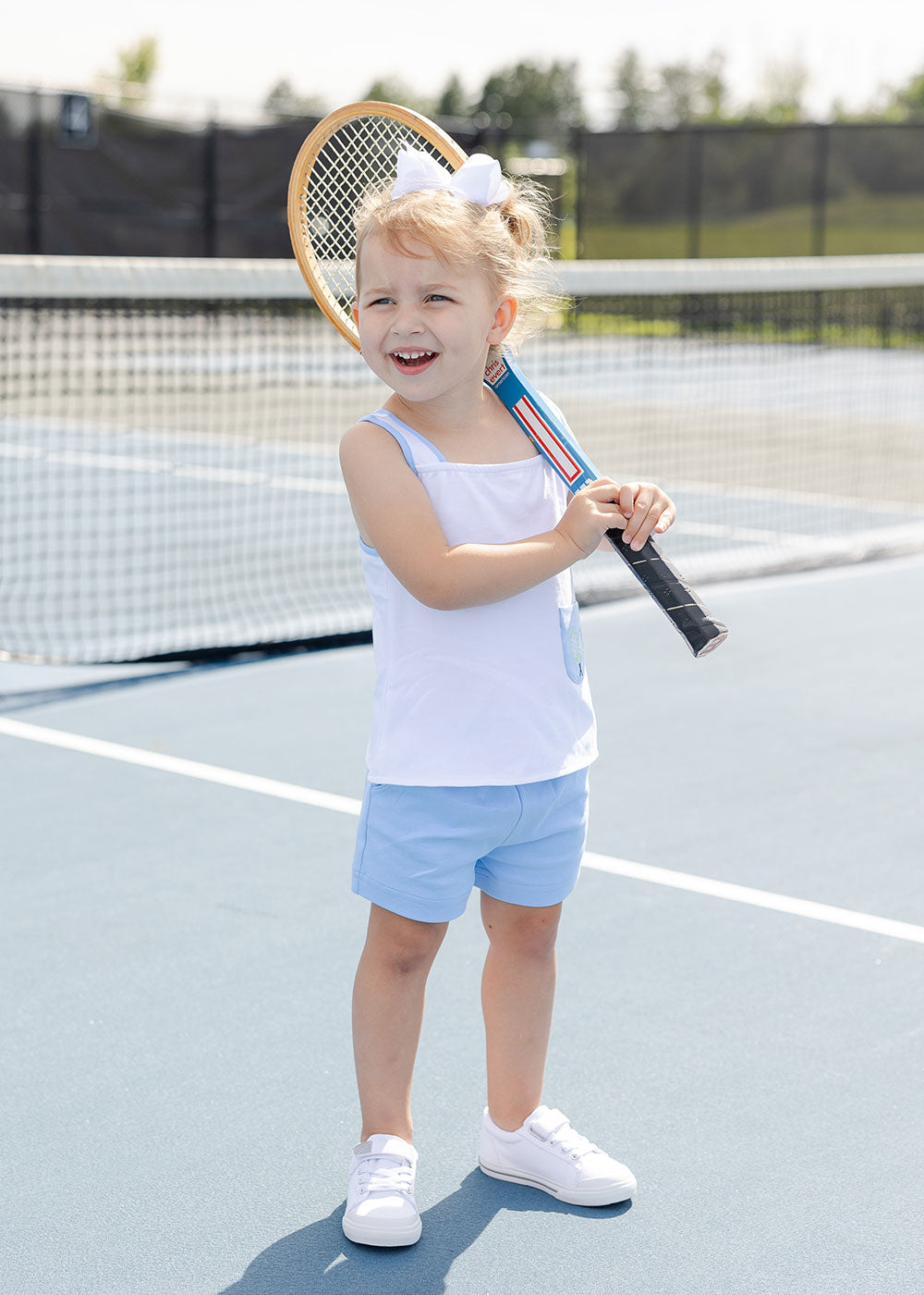 young girl on courts in knit tennis set