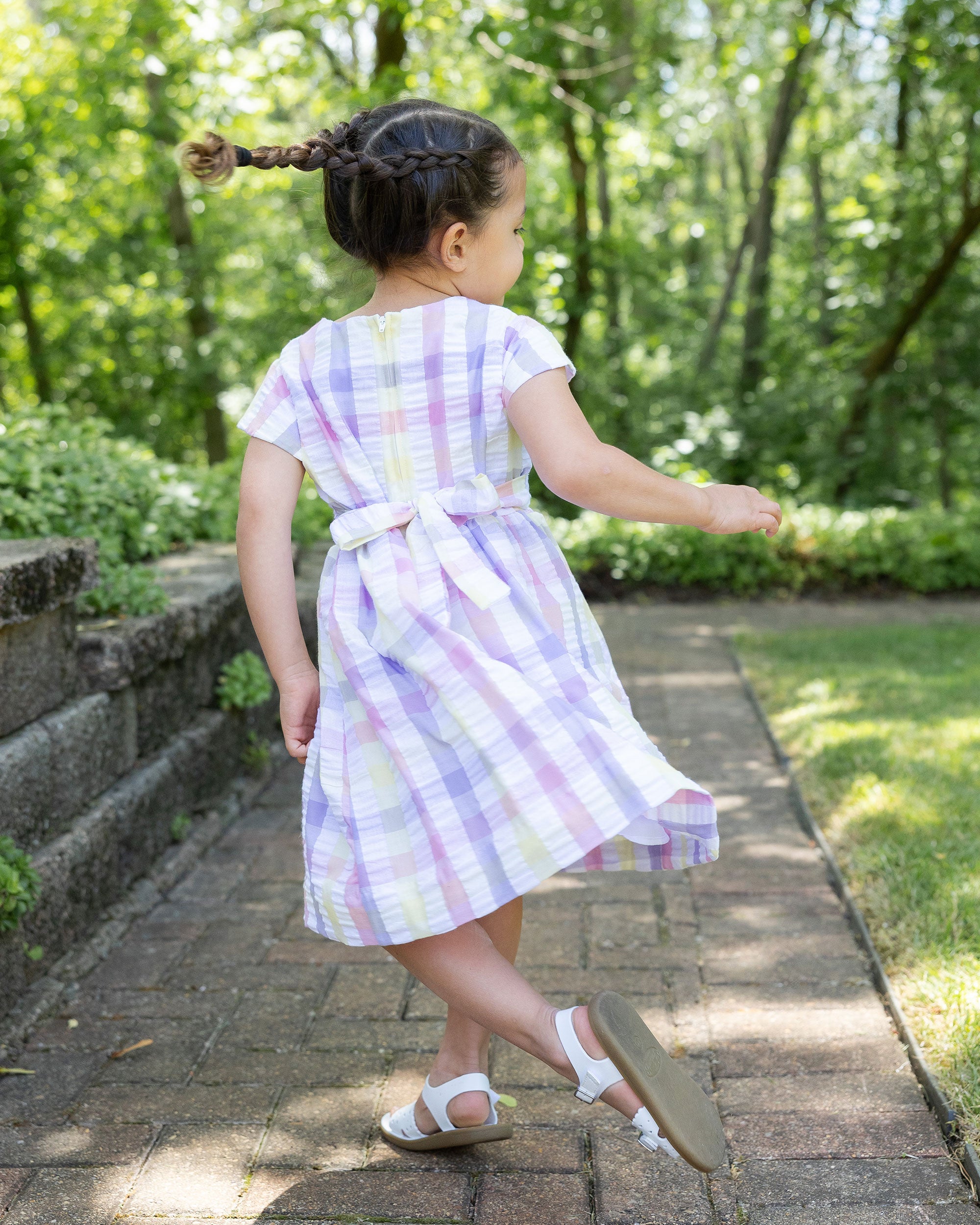 back view of girl wearing plaid dress with flowers