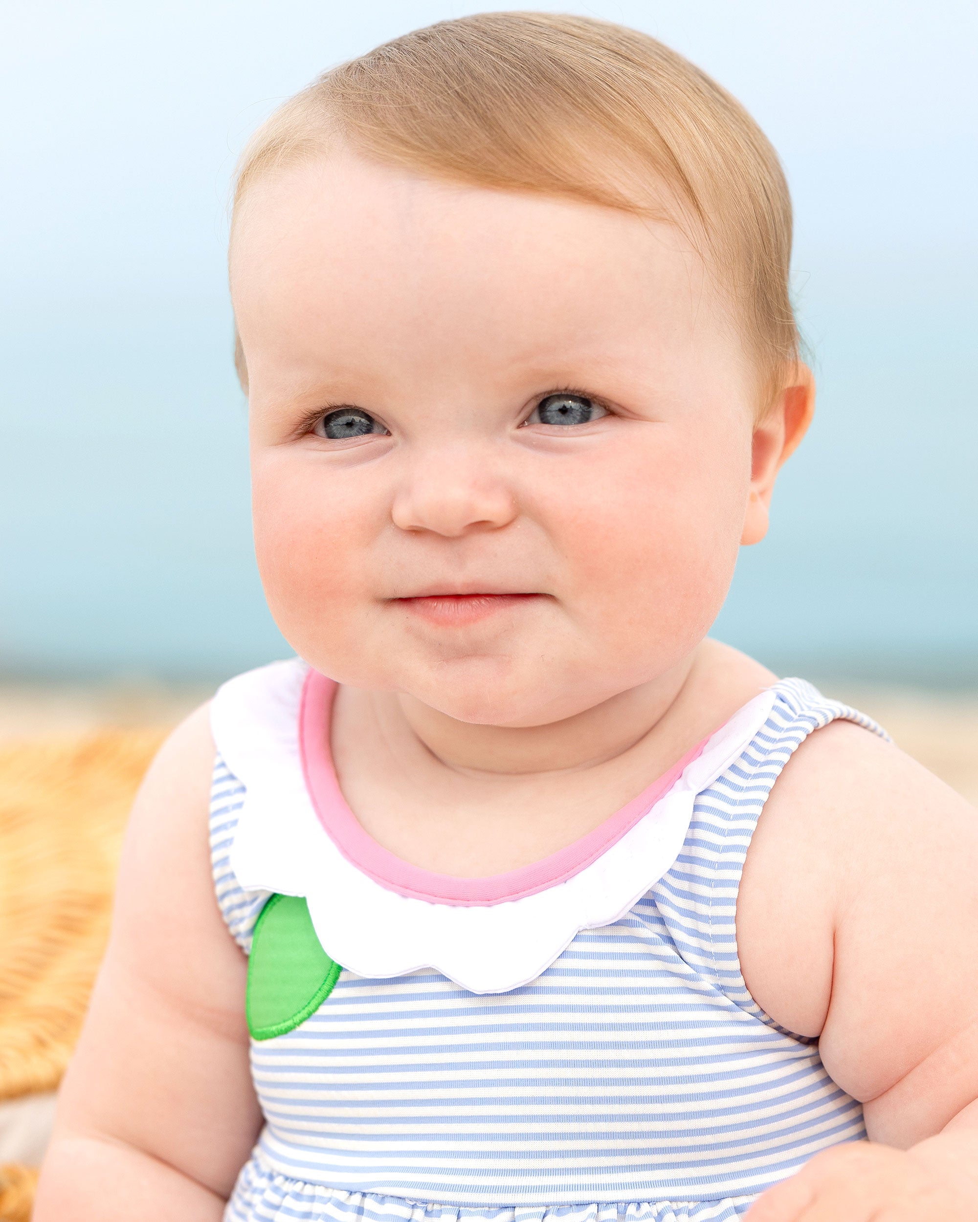 closeup of toddler in seersucker bubble swimsuit