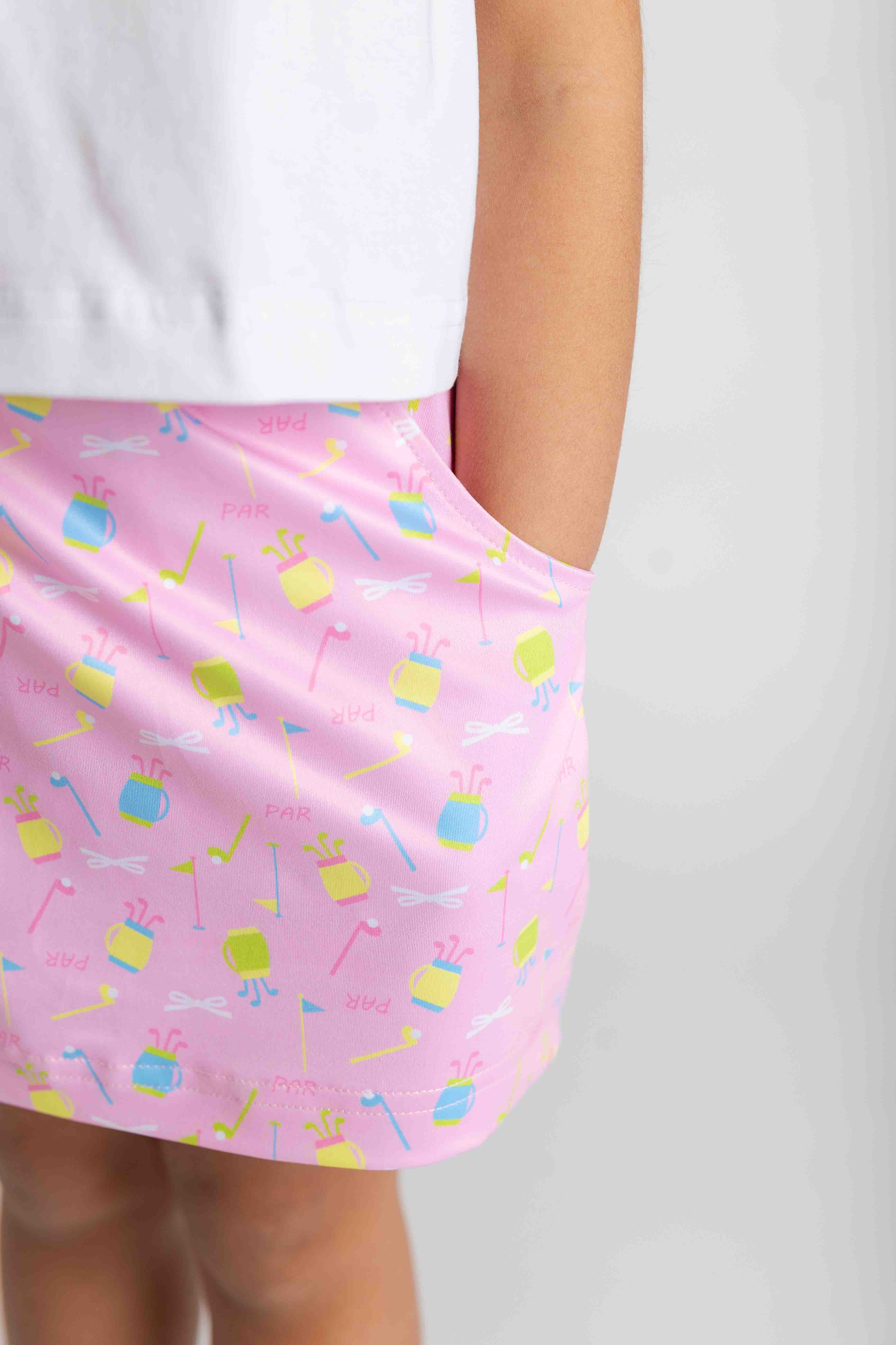 Pink skirt with colorful patterns on a plain background