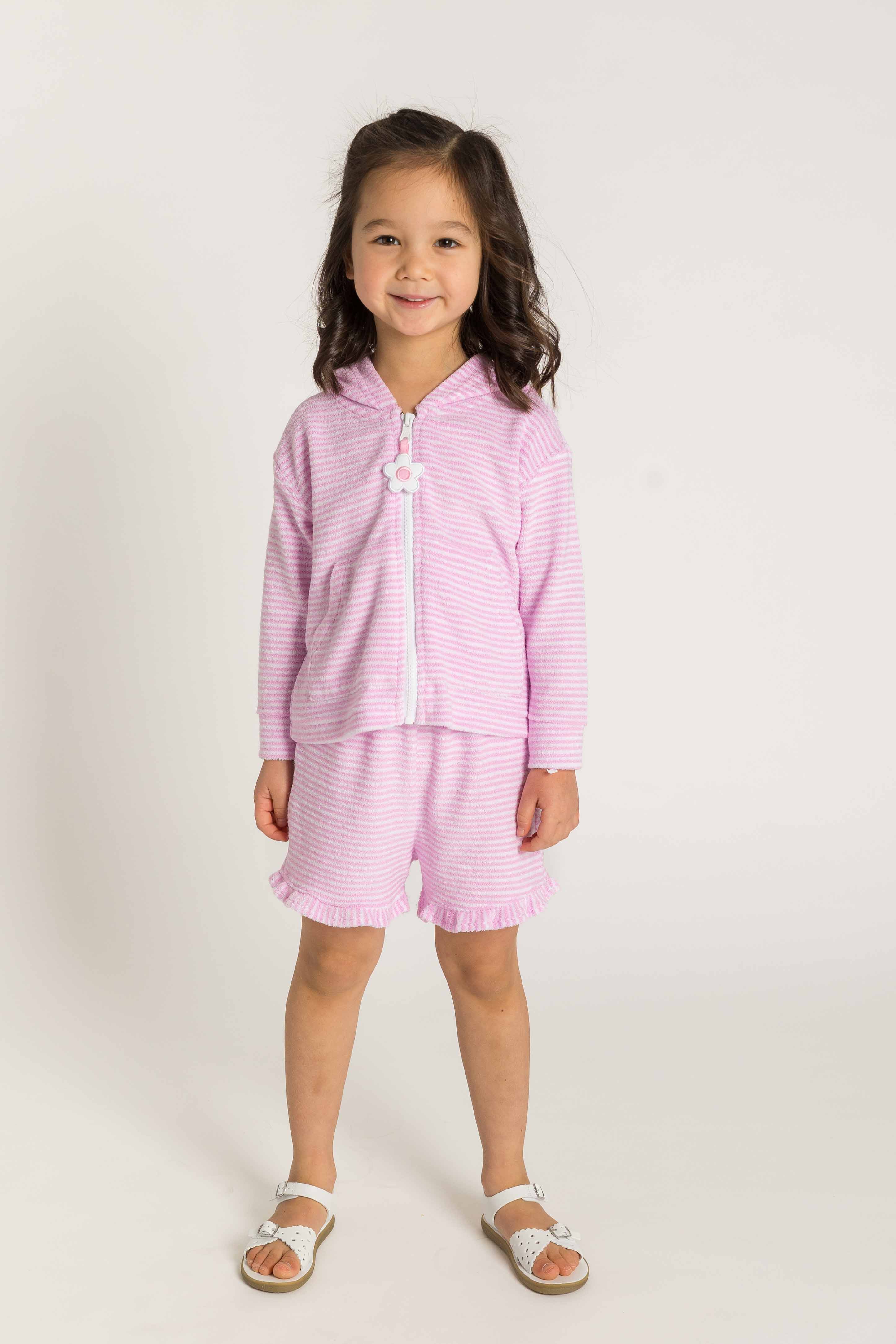 Young girl wearing a pink outfit with a white background