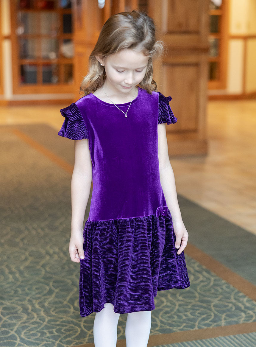 young girl wearing violet velvet dress