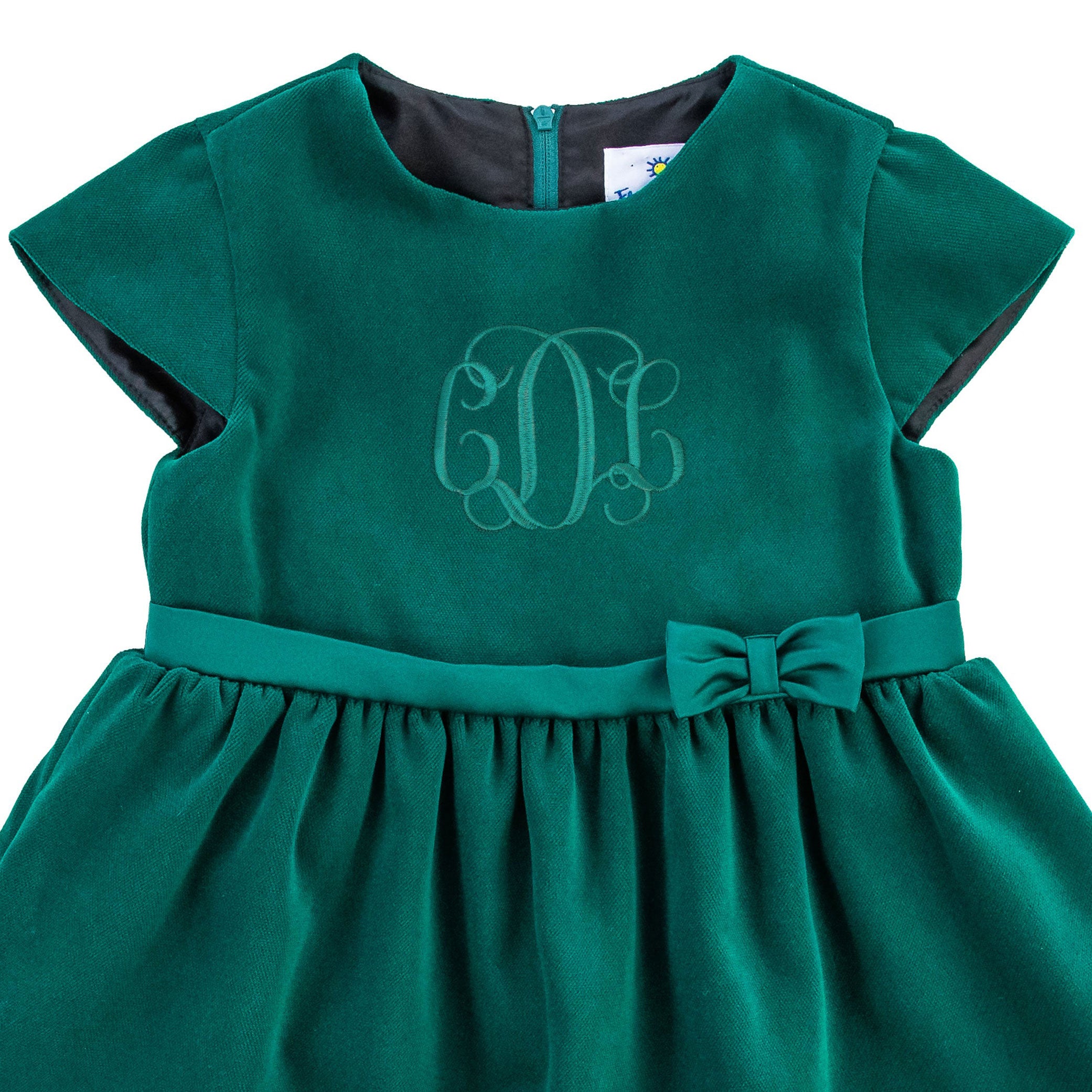 Close-up of embroidery on bib in green thread