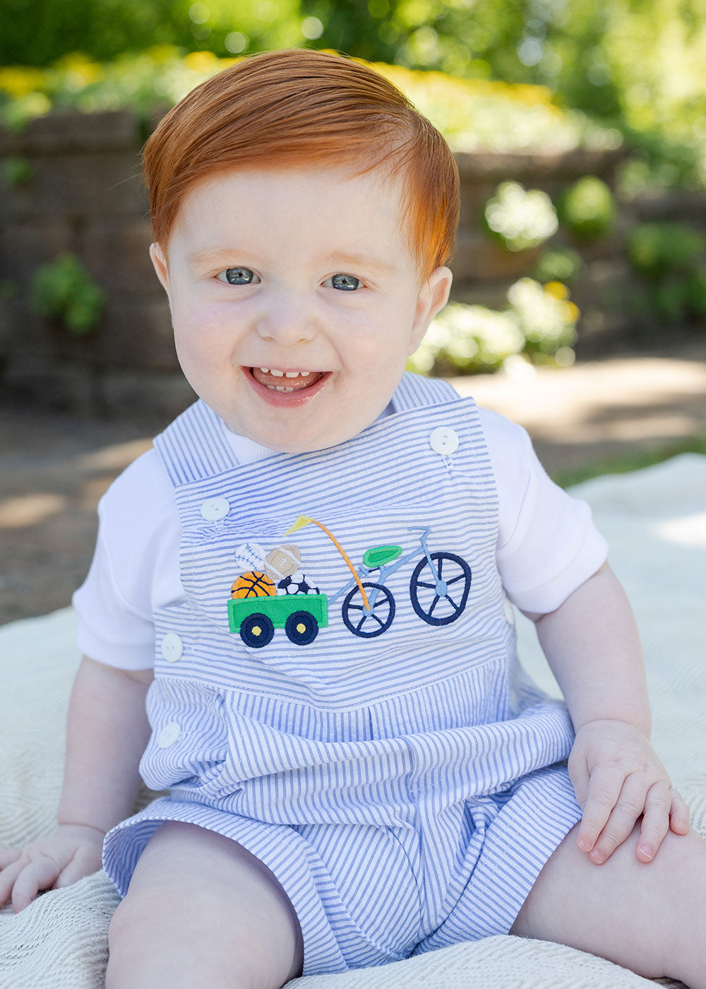 toddler boy in seersucker shortall