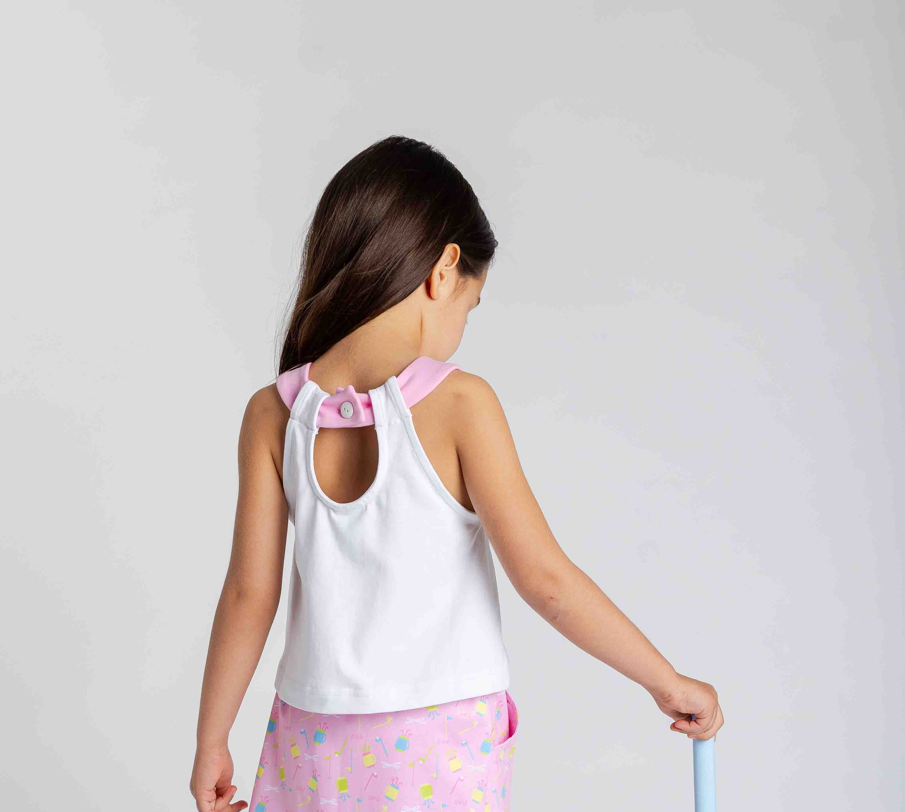girl in pink golf set with club