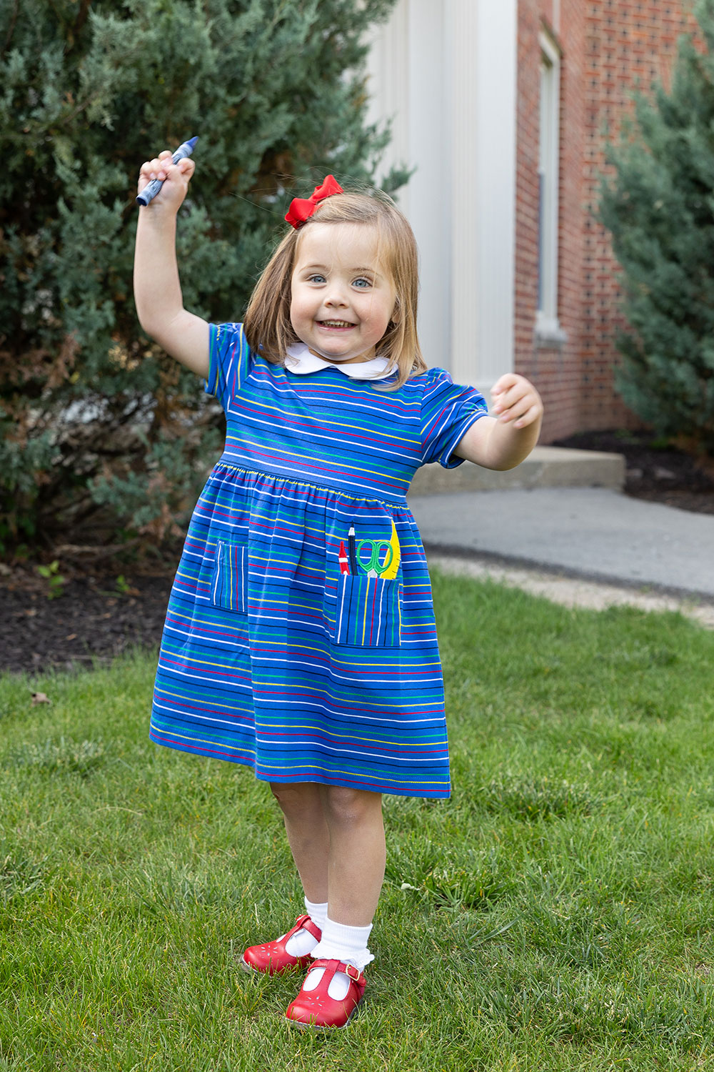 young happy girl in blue stripe dress