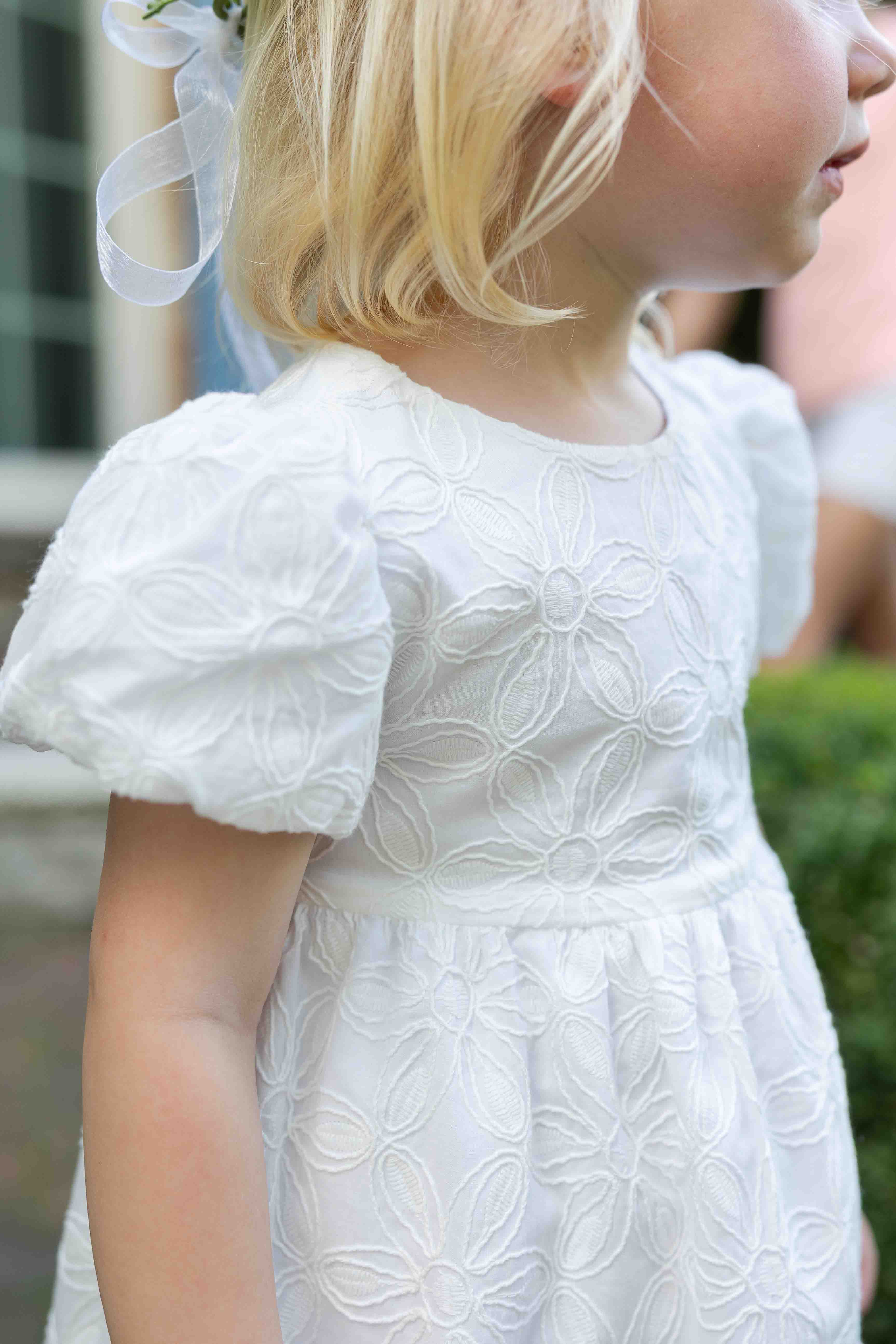 girl twirling in pleated multicolor dress