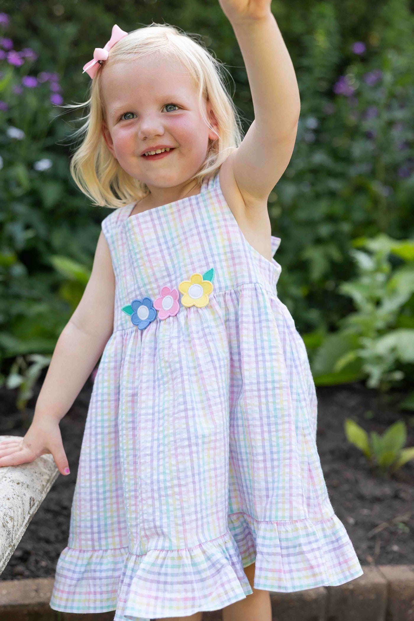 three children in a garden in plaid clothing