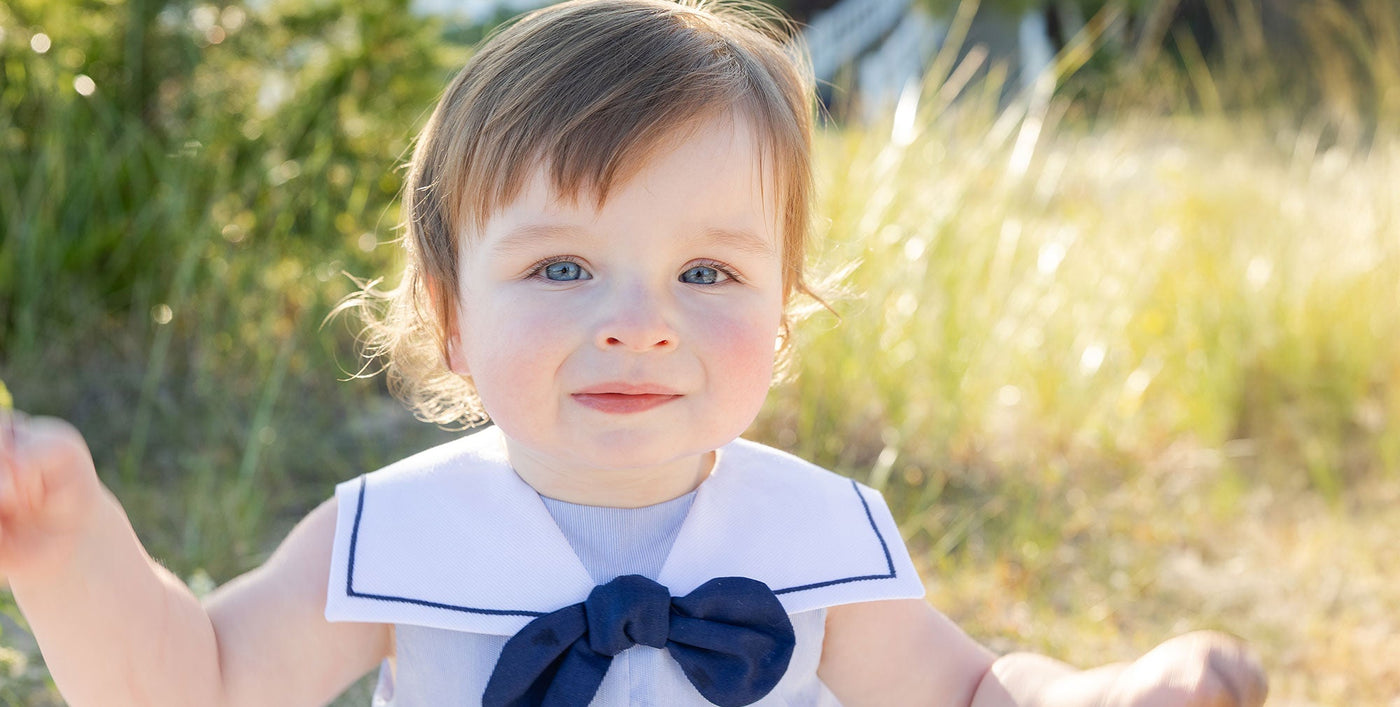 baby boy smiling outside in dog longall