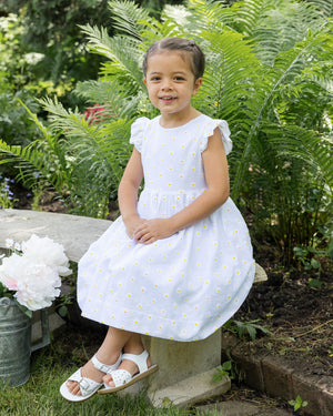 young girl in dress with daisies