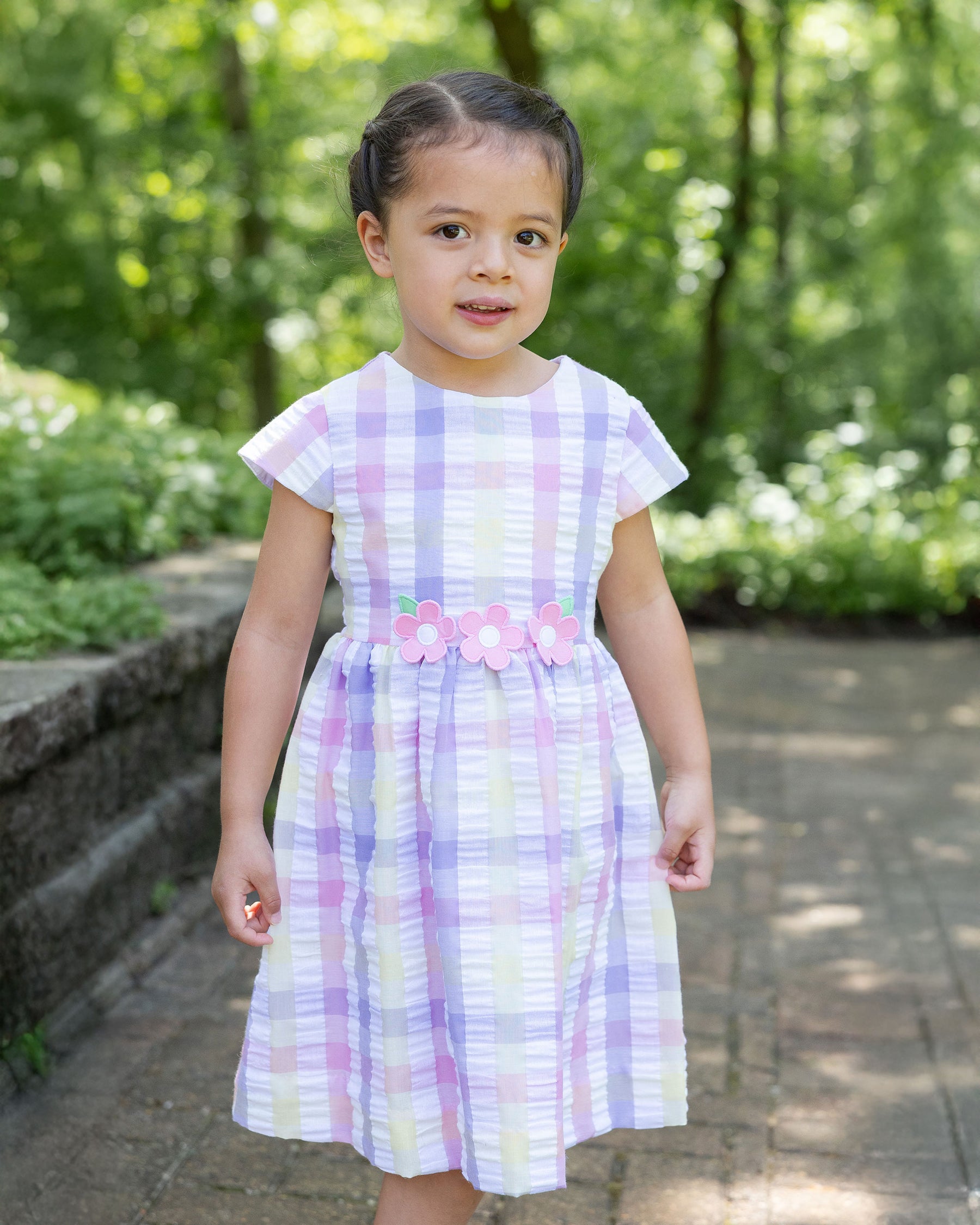 girl wearing plaid dress with flowers