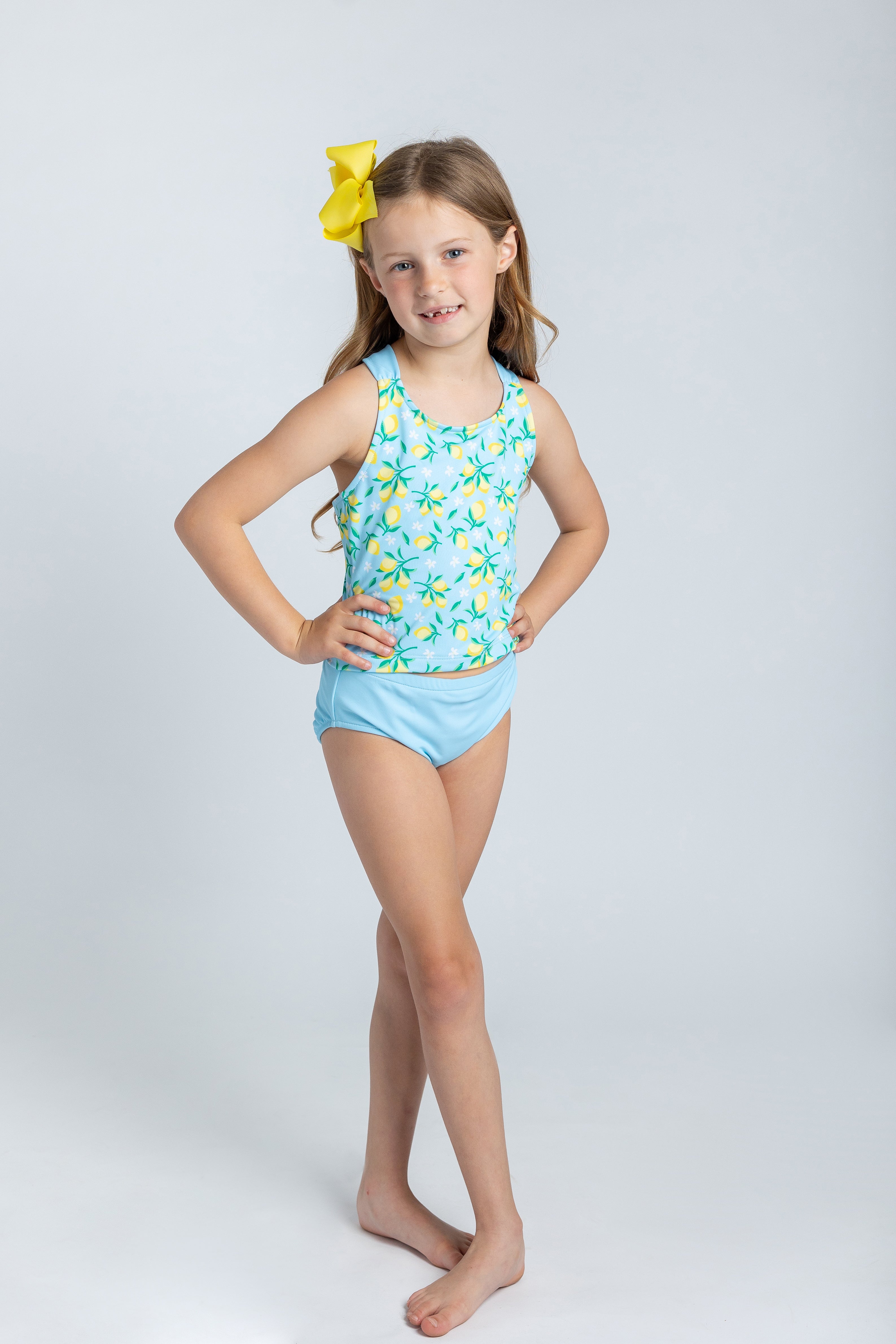 girl in lemon tankini with yellow hairbow