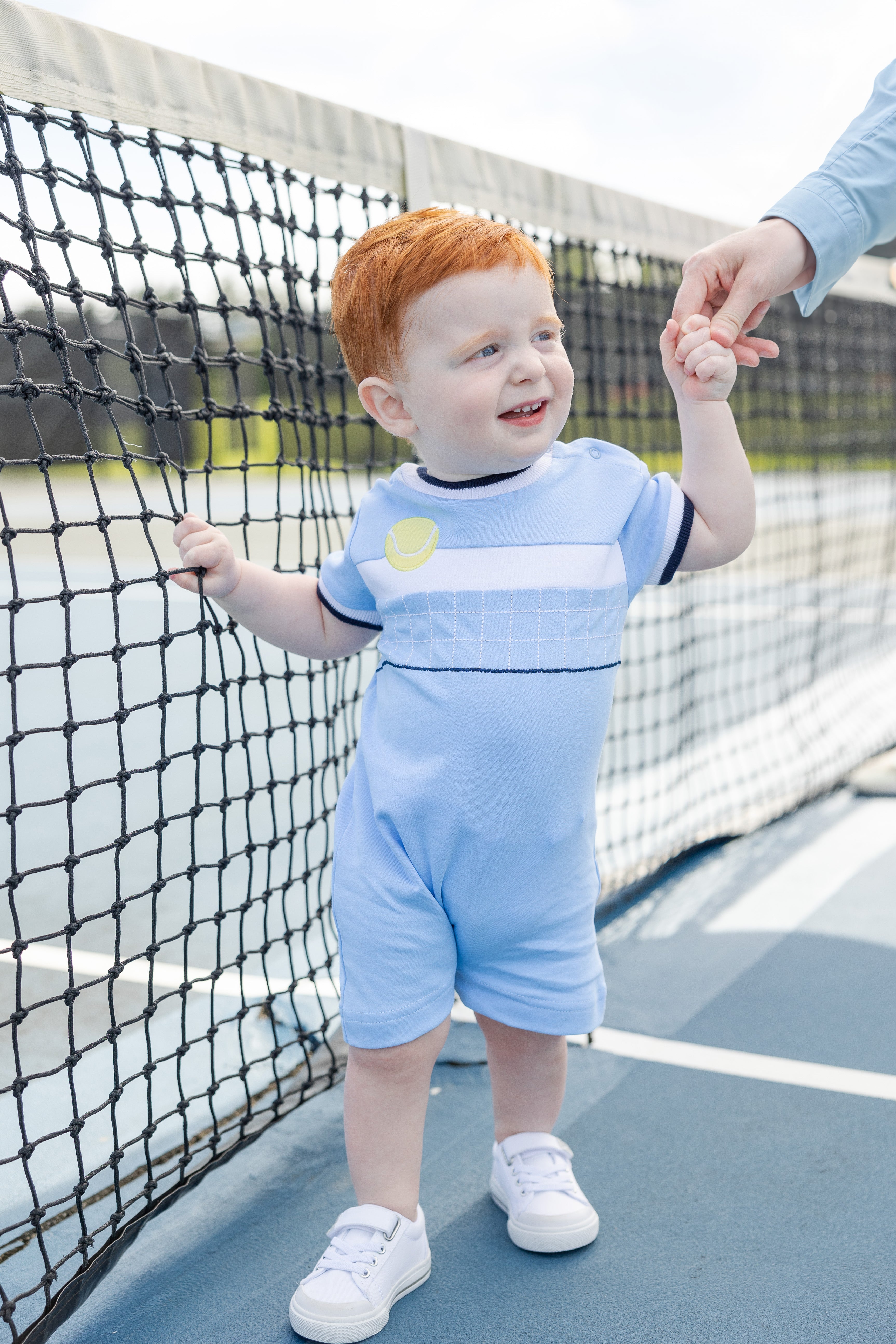 toddler boy in tennis shortall
