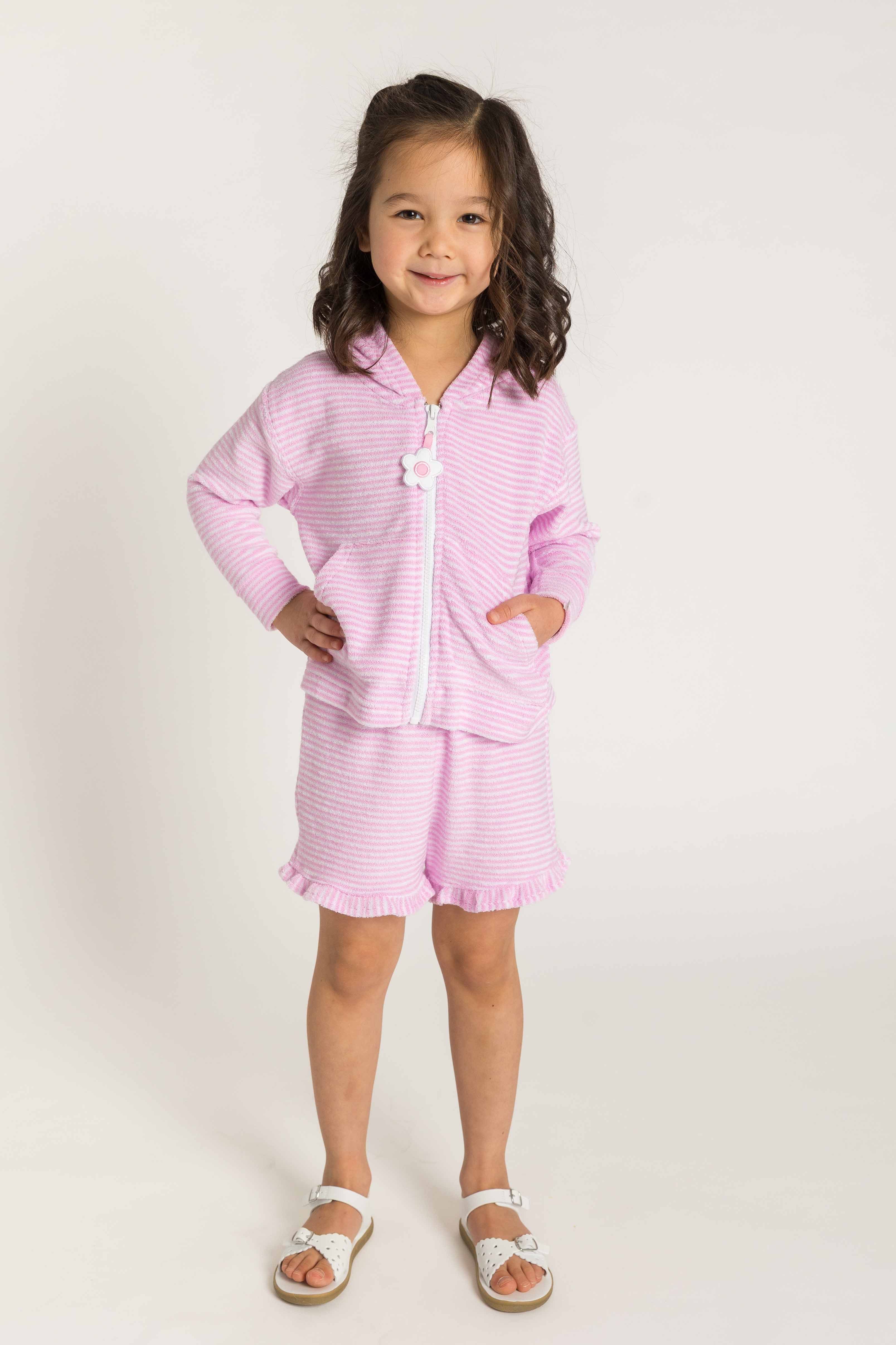 Young girl wearing a pink outfit with a white background