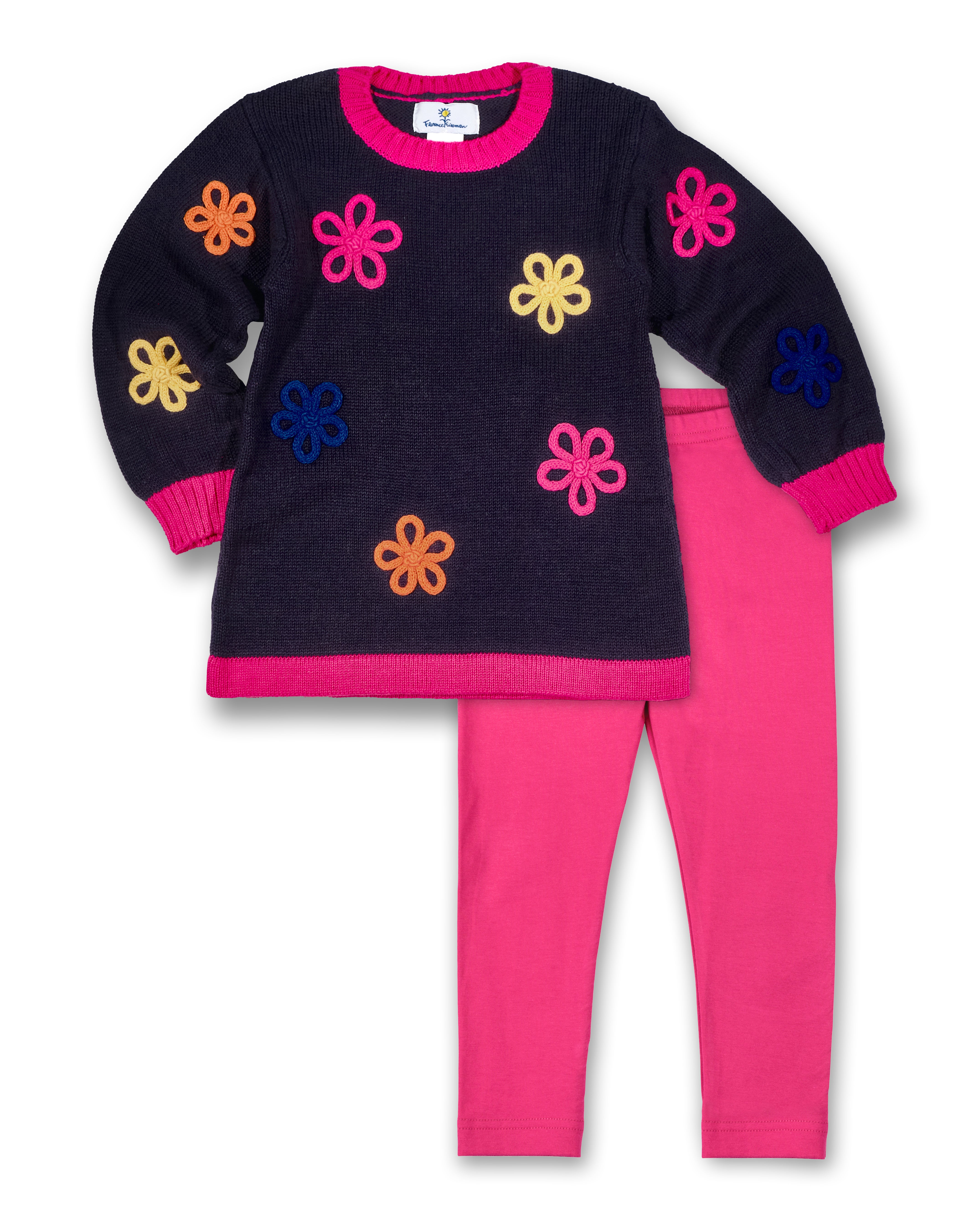 A set of children's clothing with a navy blue tunic featuring colorful floral designs and pink leggings.