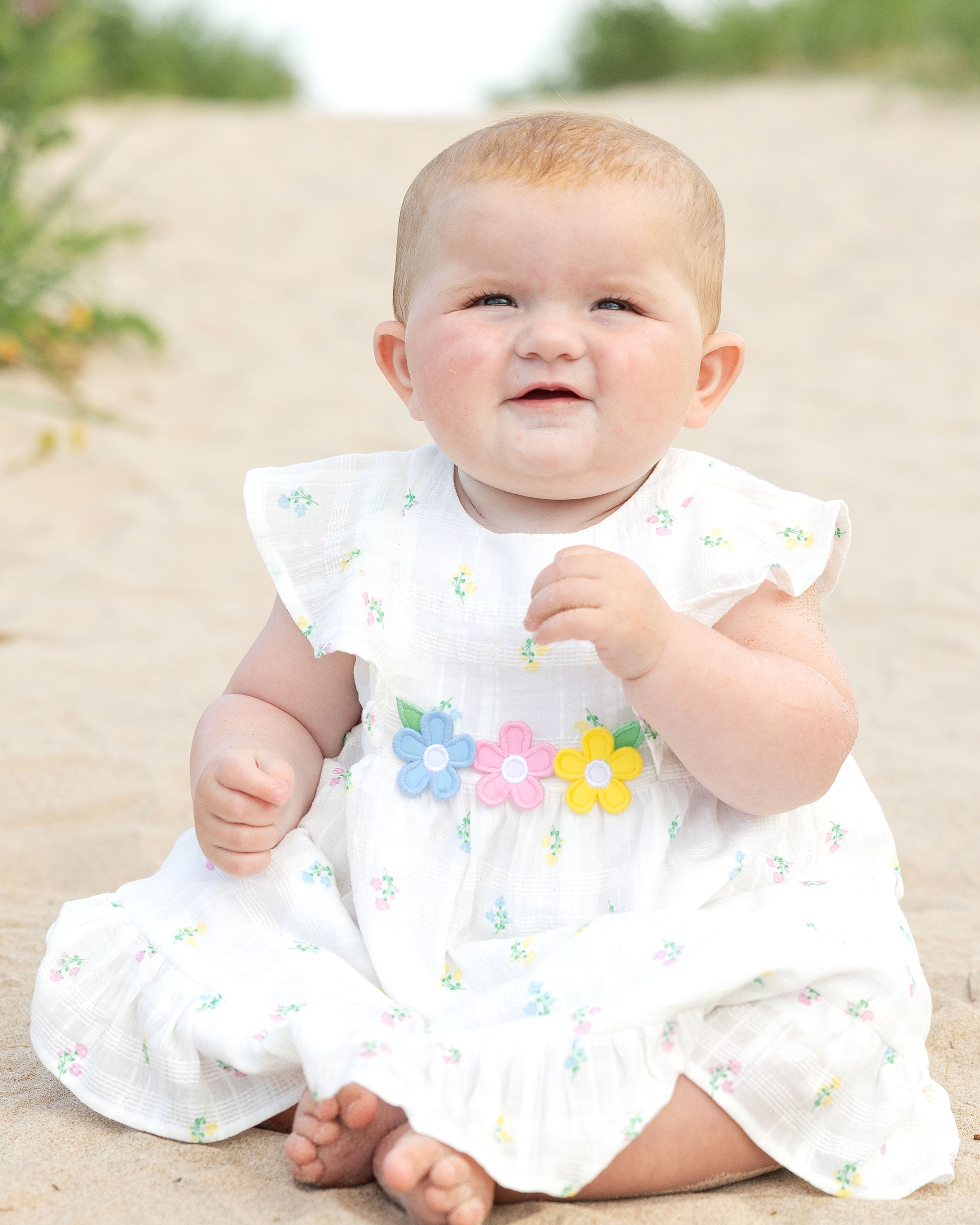 baby on beach in dress with bloomer