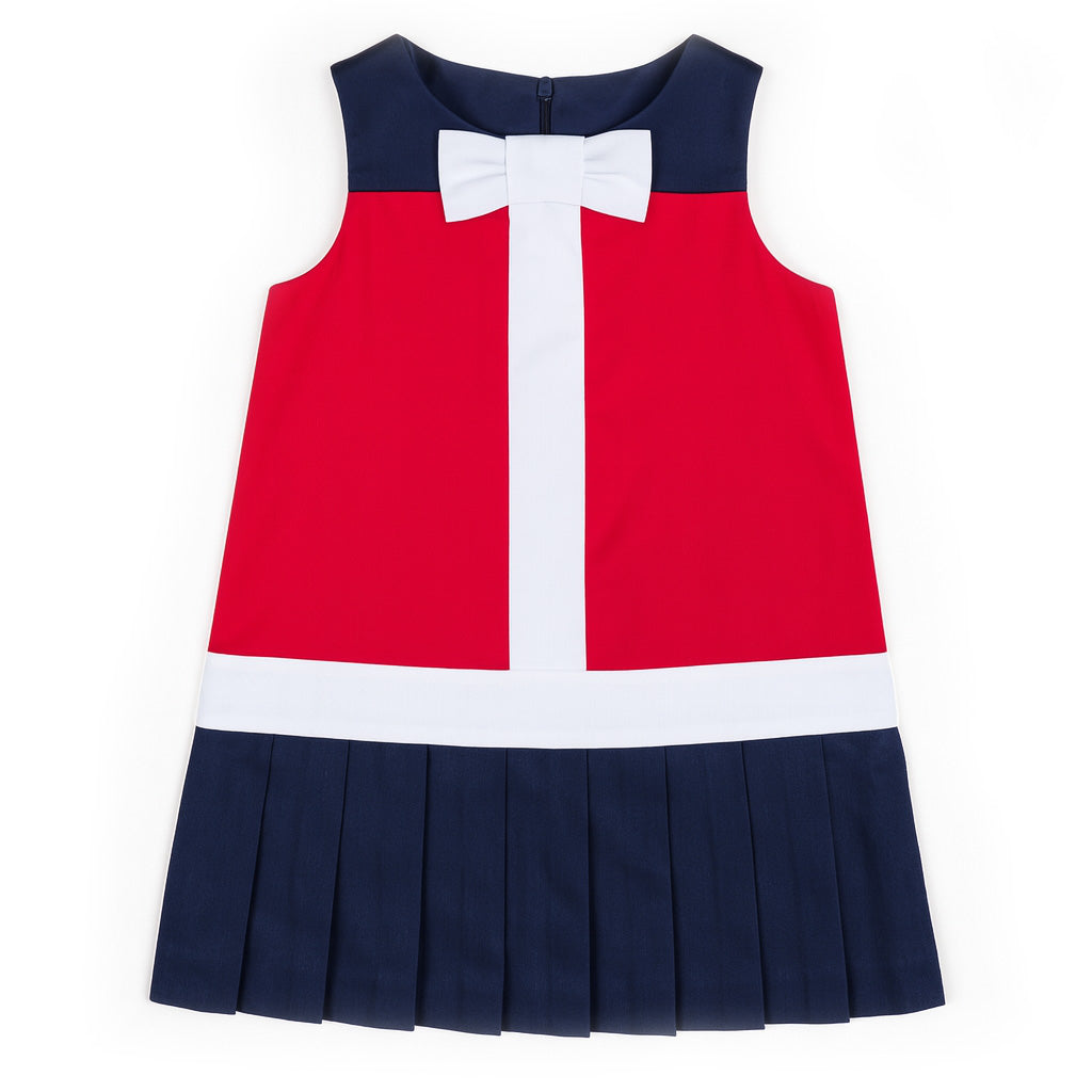 Red and navy dress with a white bow on a white background