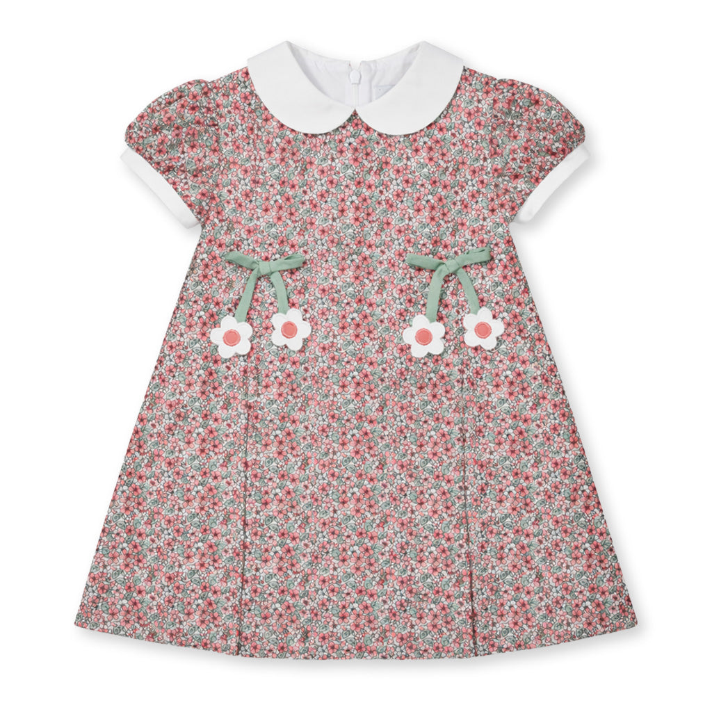 Floral dress with white collar and flower details on a white background