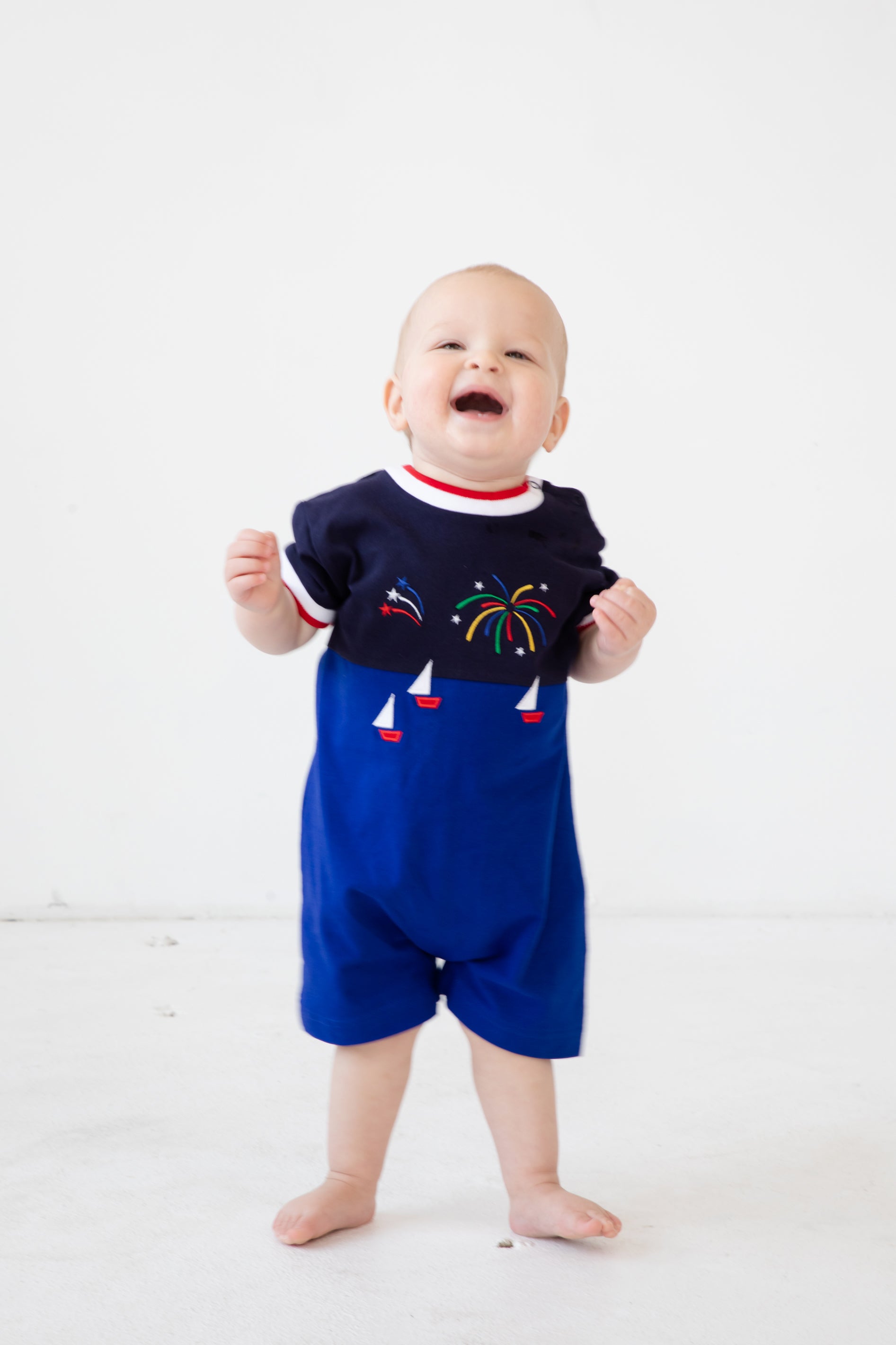 Baby wearing Knit Shortall With Boats And Fireworks