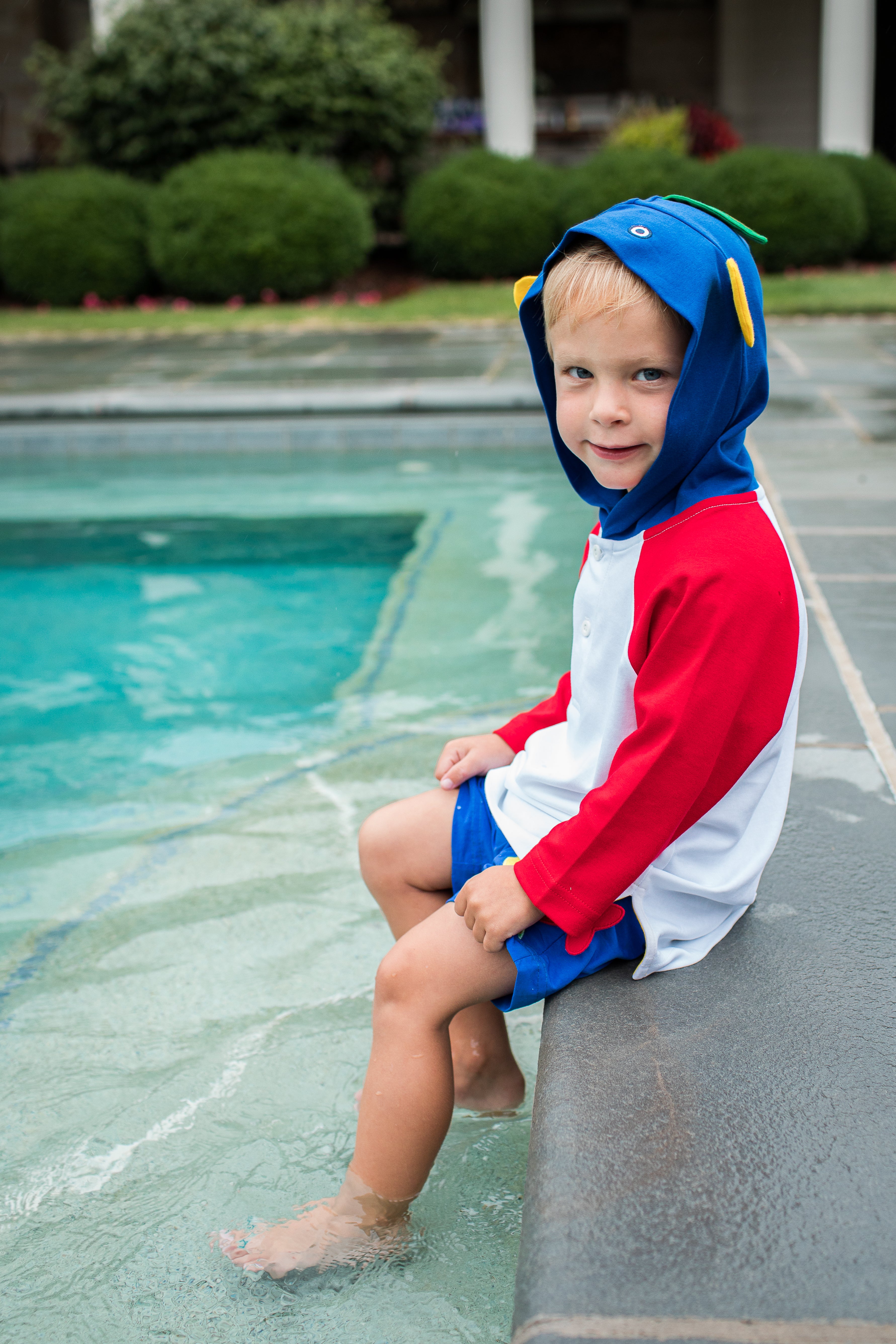 Boy wearing Red, White, Blue, and Yellow Fish Hood Coverup